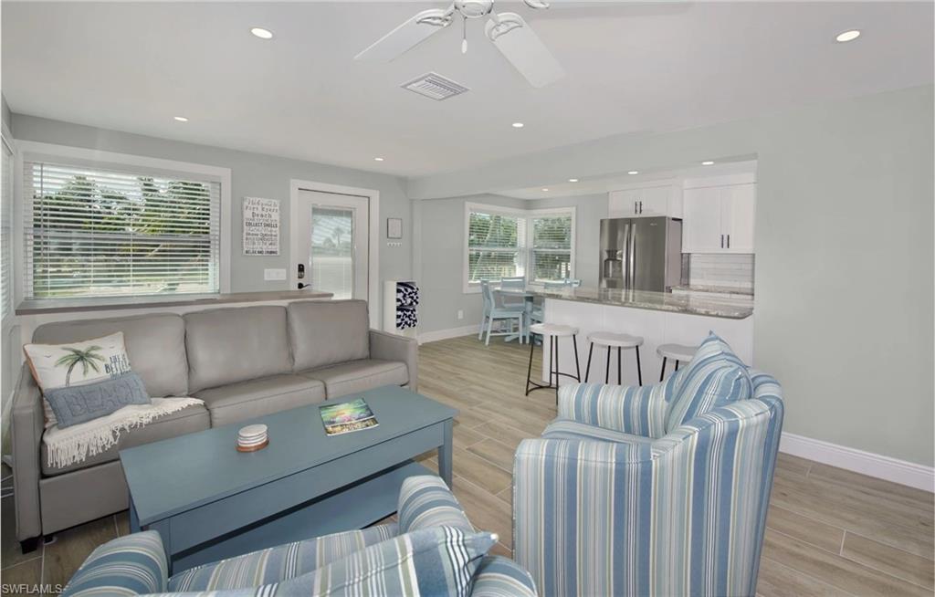Open-concept living area perfect for entertaining (Beach home 1)  - Virtually Edited Image