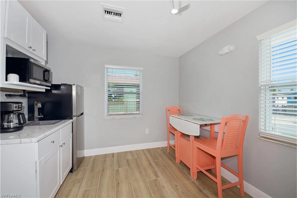 Well-equipped kitchen featuring modern cabinetry and ample counter space (Beach home 2) - Virtually Edited Image