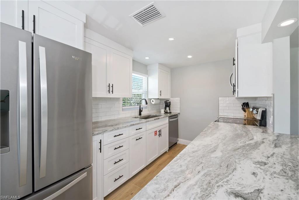 Well-equipped kitchen with a functional layout, perfect for preparing meals and entertaining guests (Beach home 1)  - Virtually Edited Image
