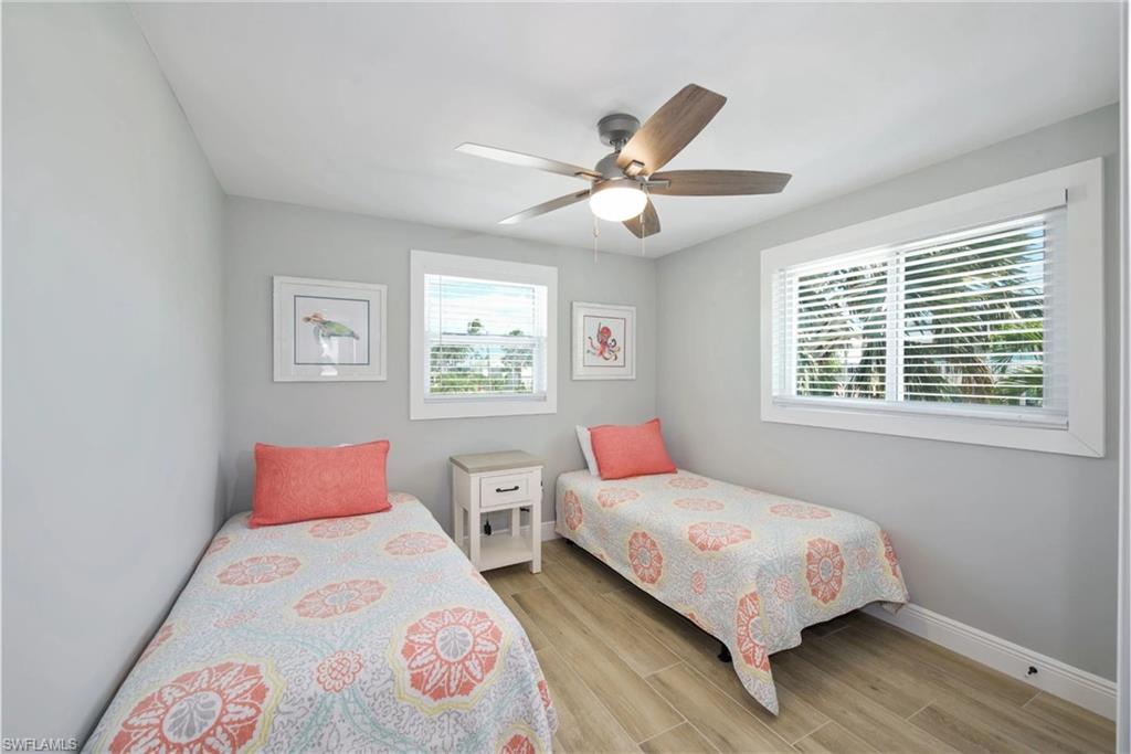 Bright and comfortable bedroom with twin beds, perfect for guests or family (Beach home 1) - Virtually Edited Image