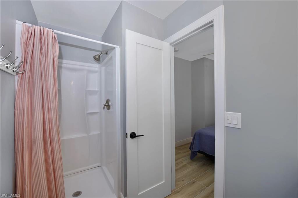 Modern bathroom with a luxurious walk-in shower and sleek fixtures (Beach home 2) - Virtually Edited Image