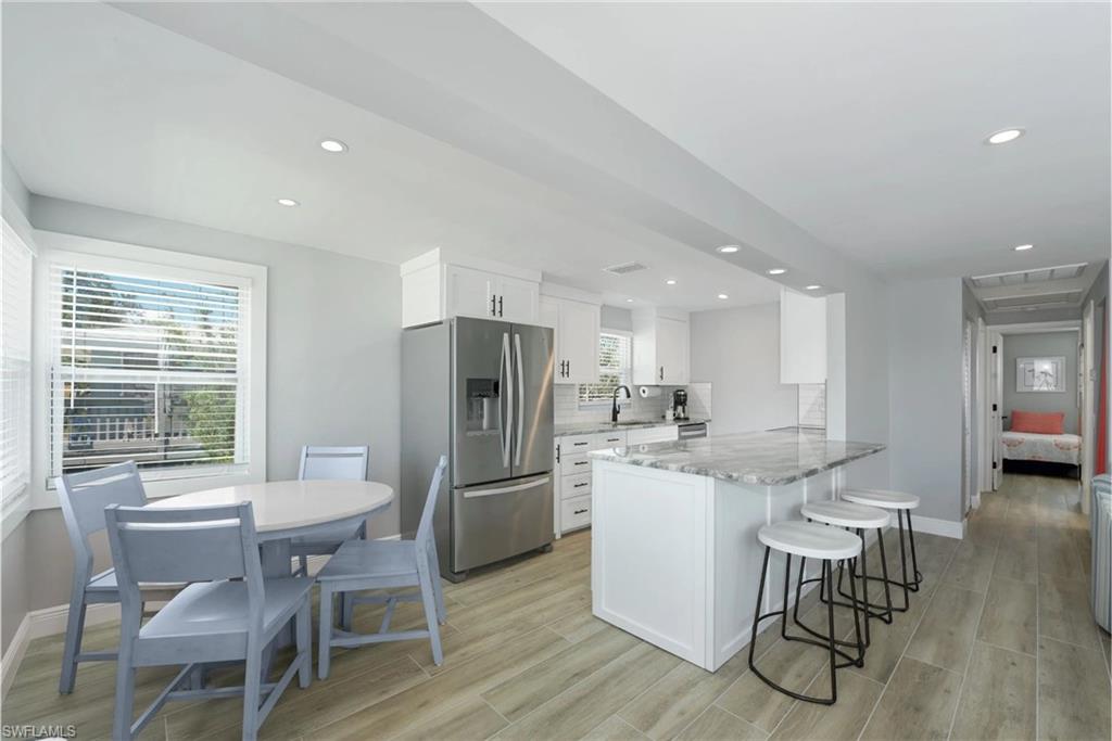 Functional kitchen and dining space with a focus on both style and practicality (Beach home 1) - Virtually Edited Image