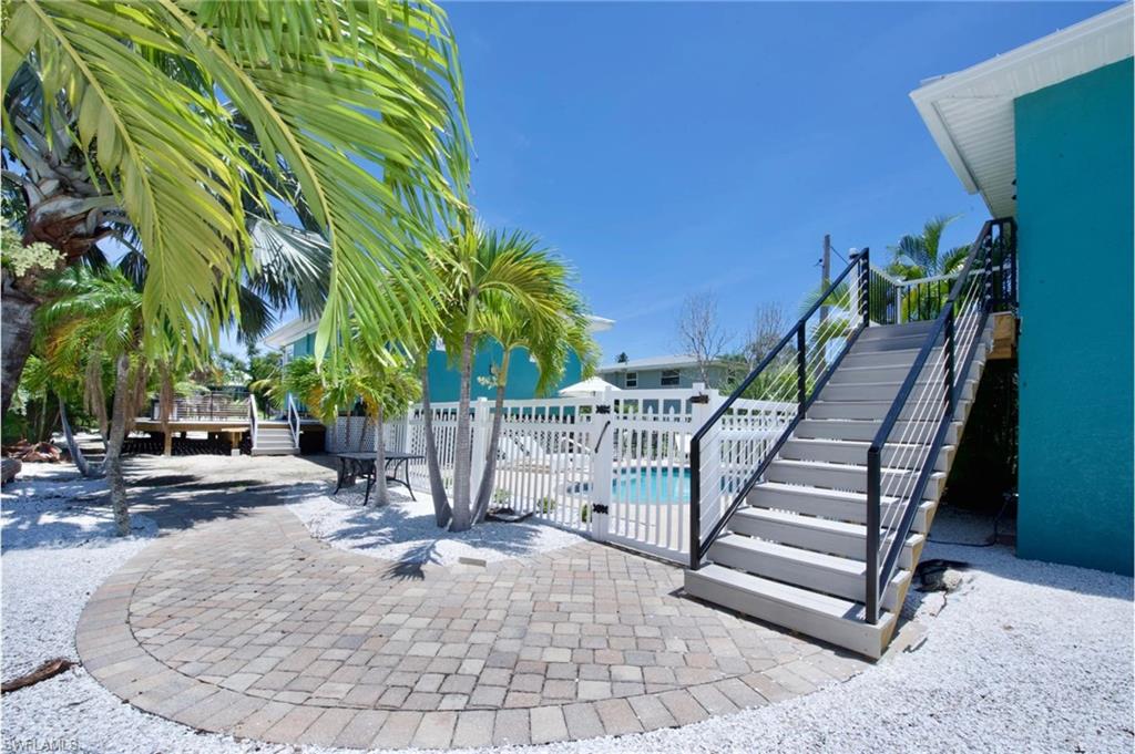 Side View: Charming outdoor patio area with convenient access to the private pool - Virtually Edited Image