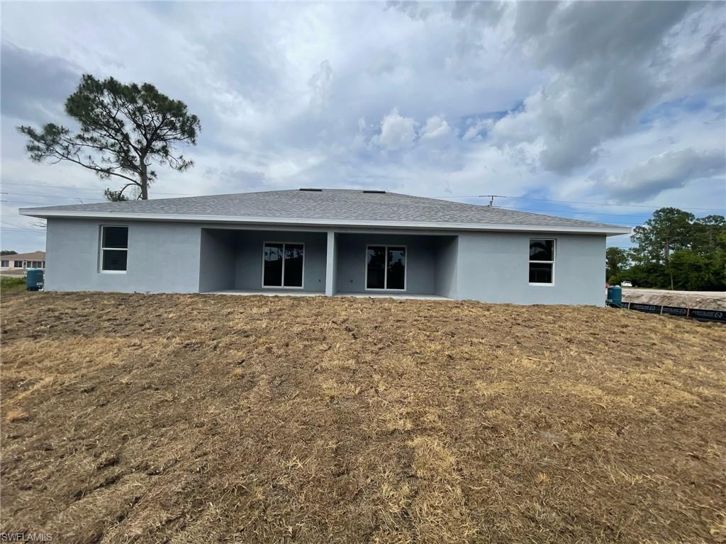 Rear view of property with stucco siding