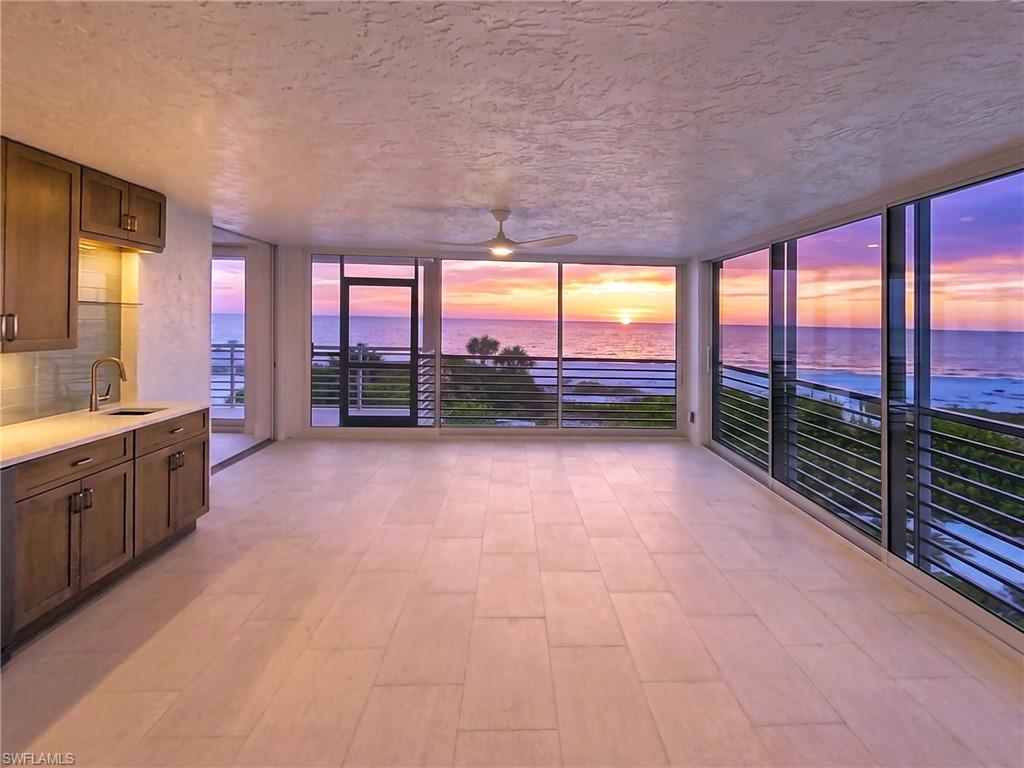 The living area flows seemlessly into the enclosed lanai. The wet bar makes for easy entertaining