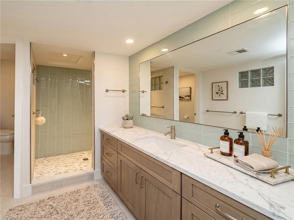 Primary bathroom and one of its two vanities - virtually staged