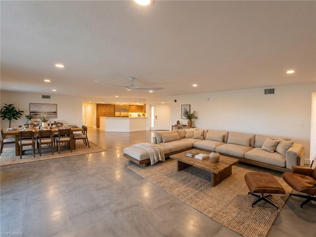 View of the living dining kitchen areas from the ocean side - virtually staged