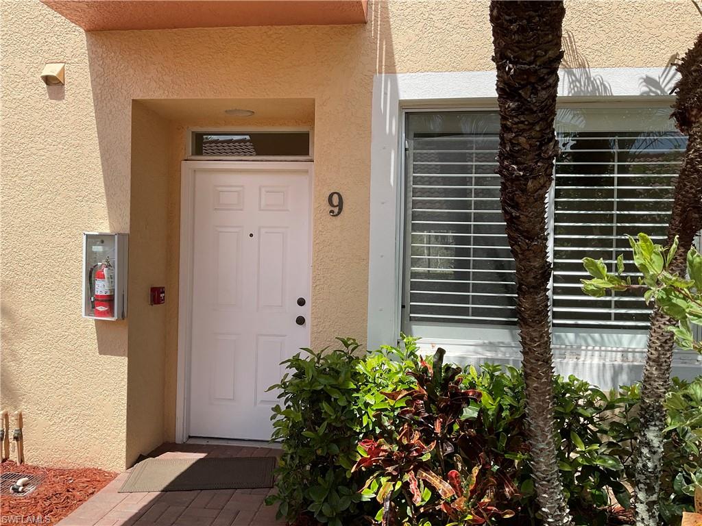 Doorway to property with stucco siding