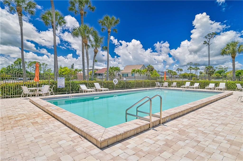 Pool with fence and a patio area