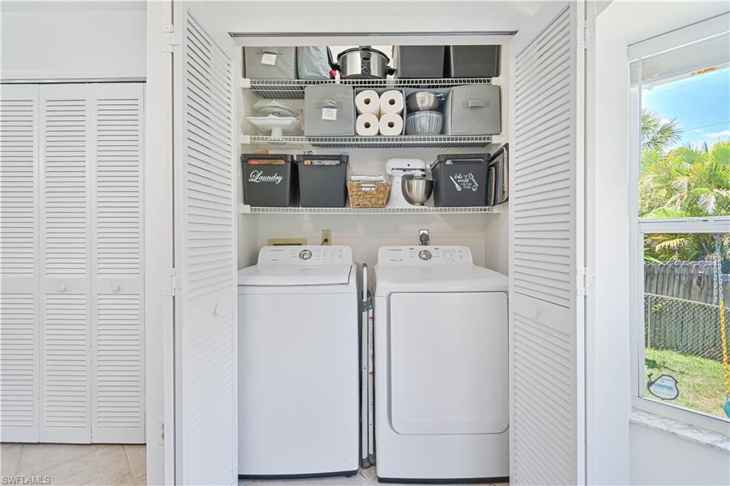 Laundry room featuring laundry area, independent washer and dryer, and tile patterned floors