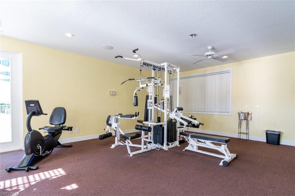 Workout area featuring a textured ceiling, a ceiling fan, plenty of natural light, and recessed lighting