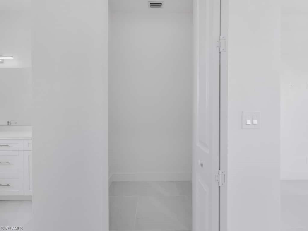 Spare room with a ceiling fan, a raised ceiling, and recessed lighting