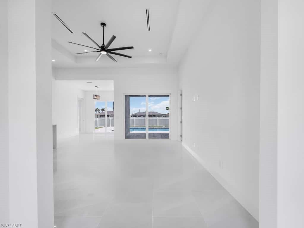 Unfurnished living room featuring ceiling fan and recessed lighting