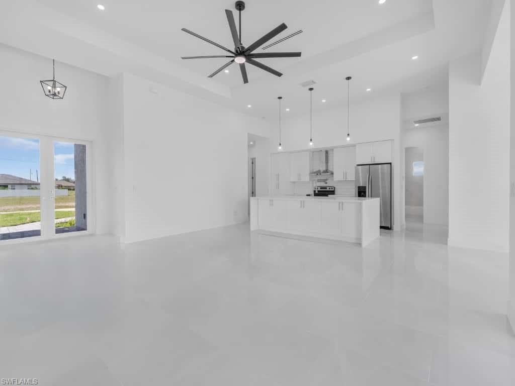 Kitchen featuring white cabinets, ceiling fan, decorative light fixtures, light countertops, and dishwasher