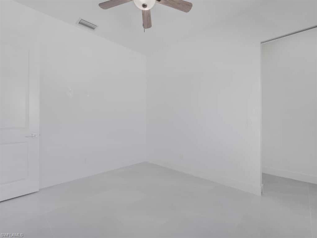 Spare room featuring recessed lighting, ceiling fan, and a tray ceiling