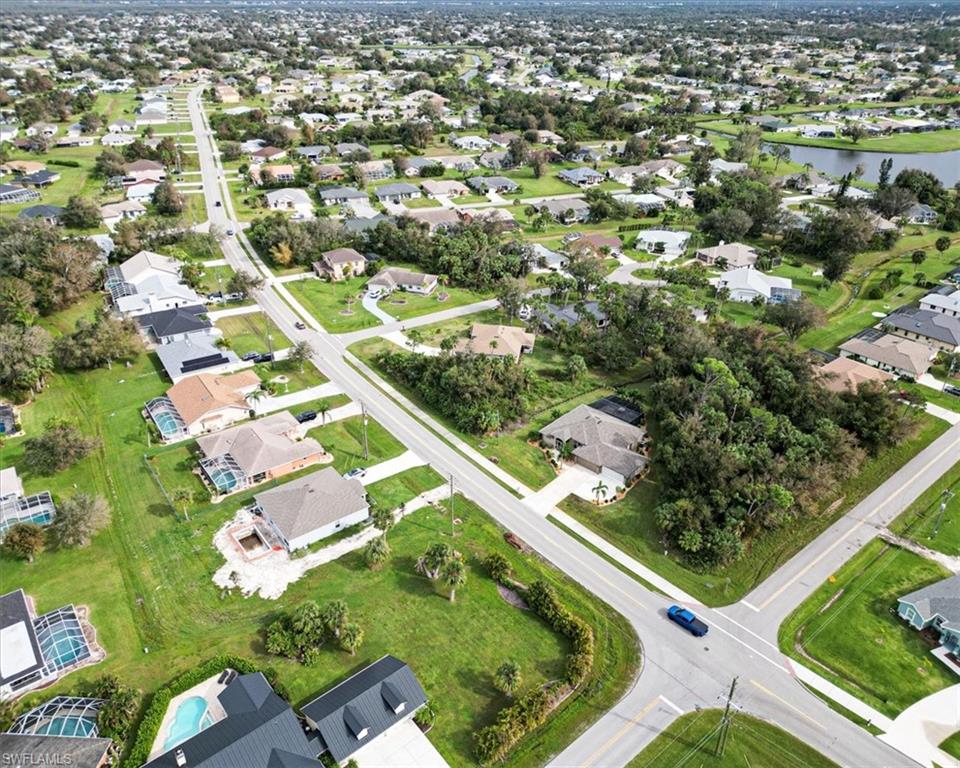 Birds eye view of property with a water view