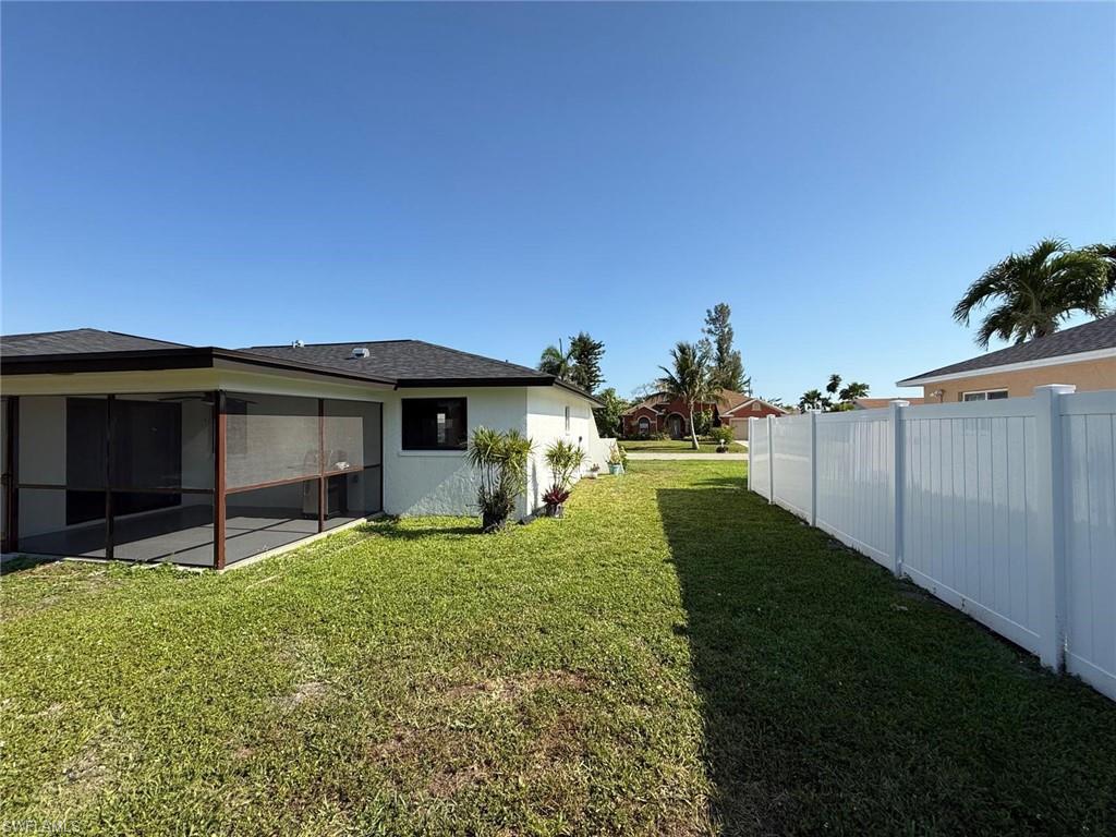 View of yard featuring fence