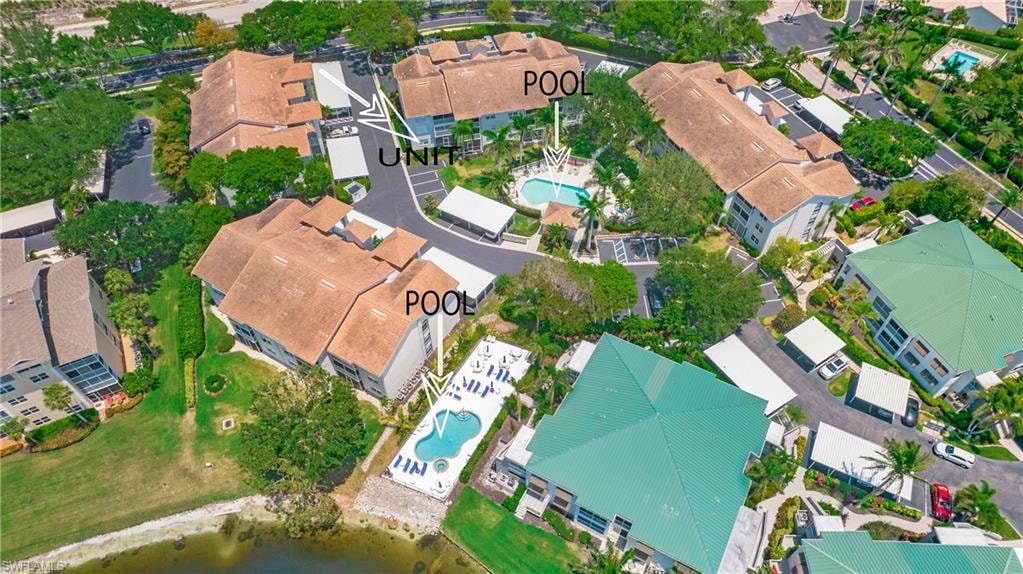 View of property location featuring a pool area and nearby suburban area