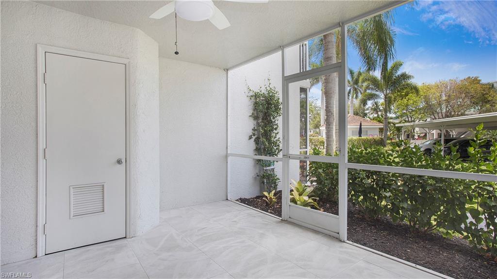 Unfurnished sunroom with a textured wall and floor to ceiling windows