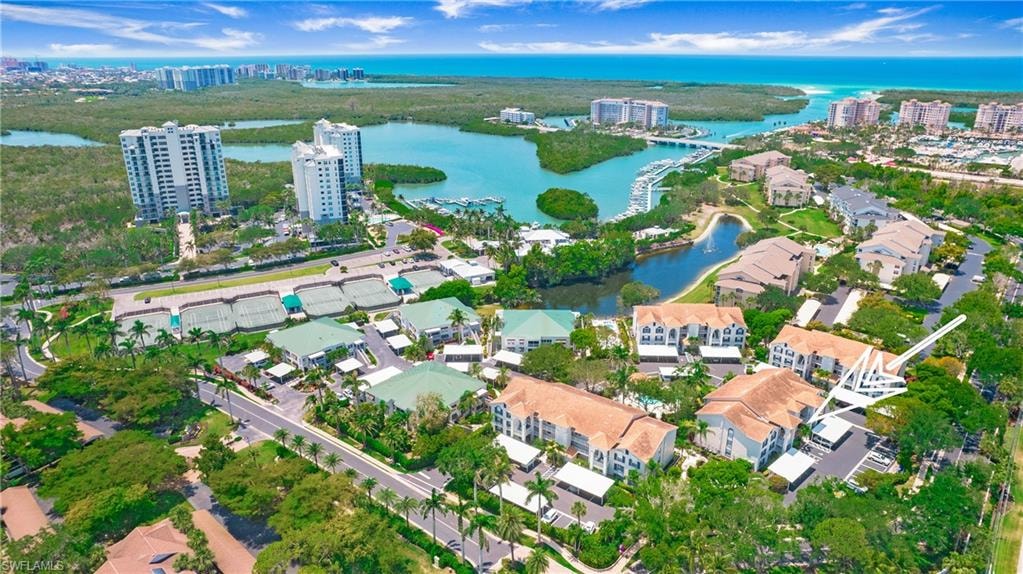 Aerial overview of property's location featuring a nearby body of water and nearby urban area