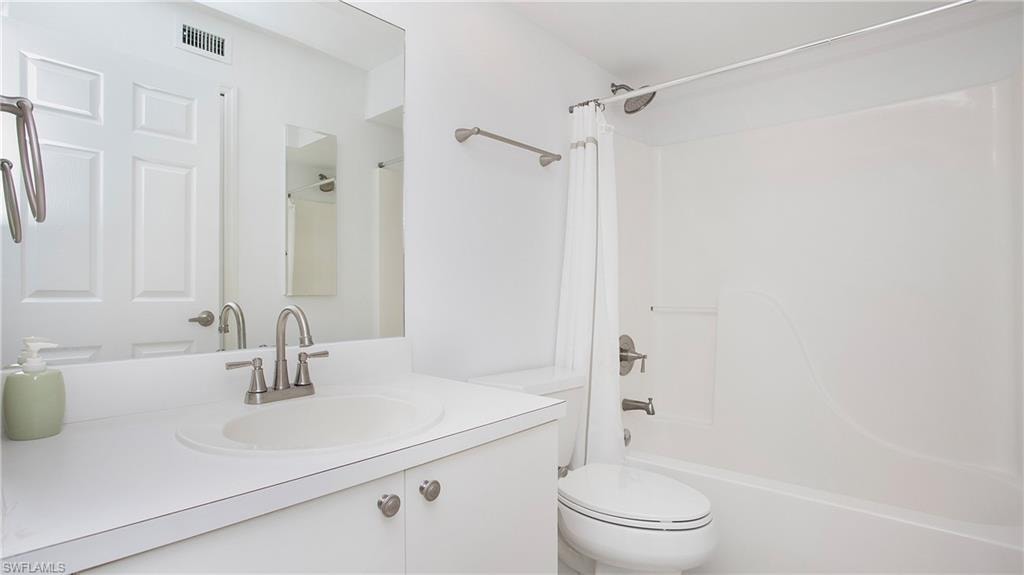 Second Full bath with toilet,  shower combination, and vanity