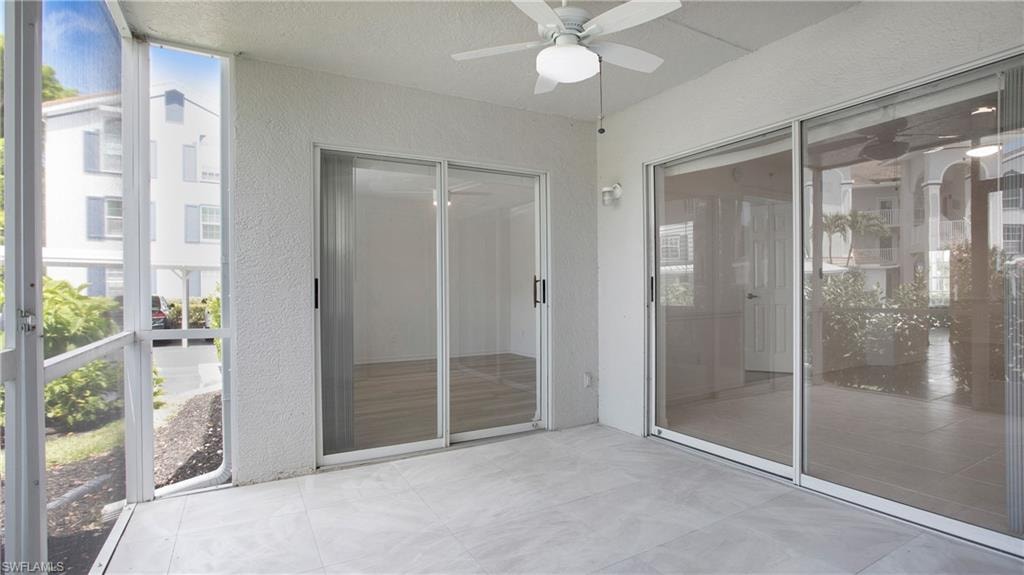 Unfurnished sunroom with a ceiling fan and plenty of natural light