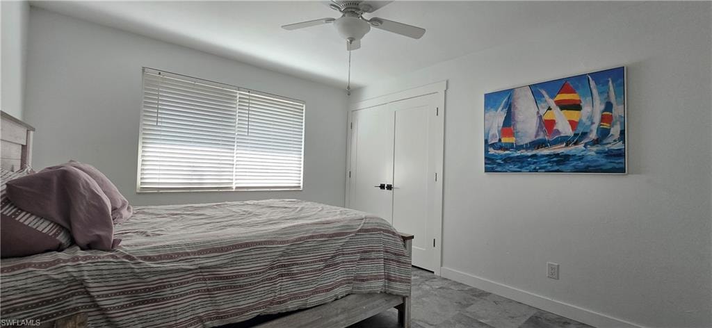 Bedroom with baseboards and ceiling fan