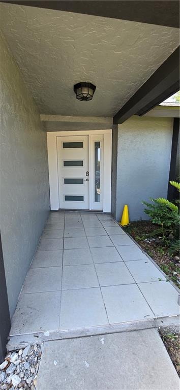 Property entrance with stucco siding