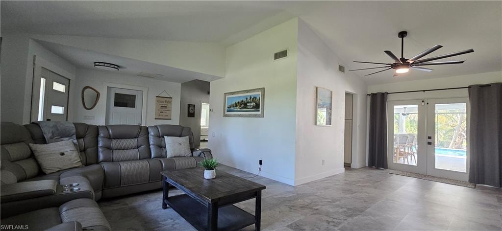 Living room with french doors, a ceiling fan, baseboards, and high vaulted ceiling
