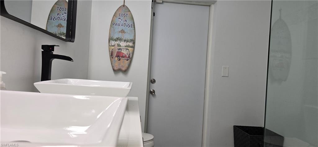 Full bathroom featuring a sink and toilet