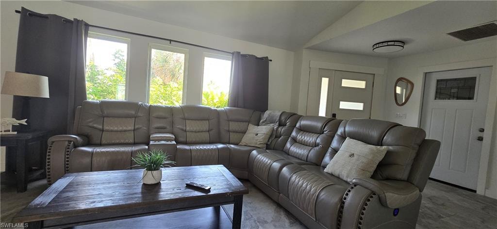 Living room featuring vaulted ceiling