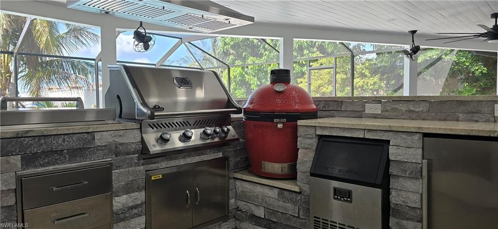 View of patio / terrace featuring exterior kitchen, grilling area, and a lanai