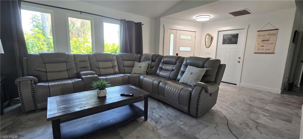 Living room with lofted ceiling and baseboards