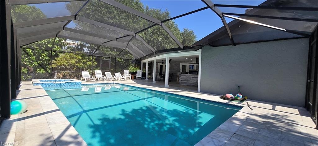 View of pool with a patio, a pool with connected hot tub, and ceiling fan