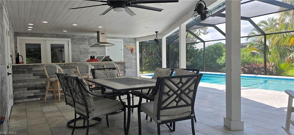View of patio with a ceiling fan, an outdoor pool, french doors, and glass enclosure