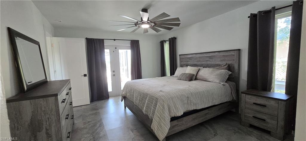 Bedroom featuring access to exterior and a ceiling fan