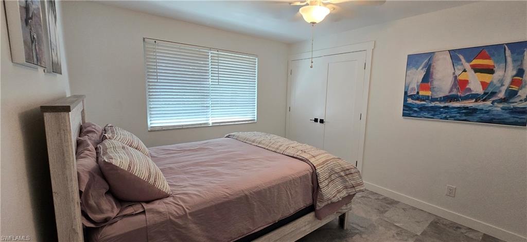 Bedroom with baseboards and ceiling fan