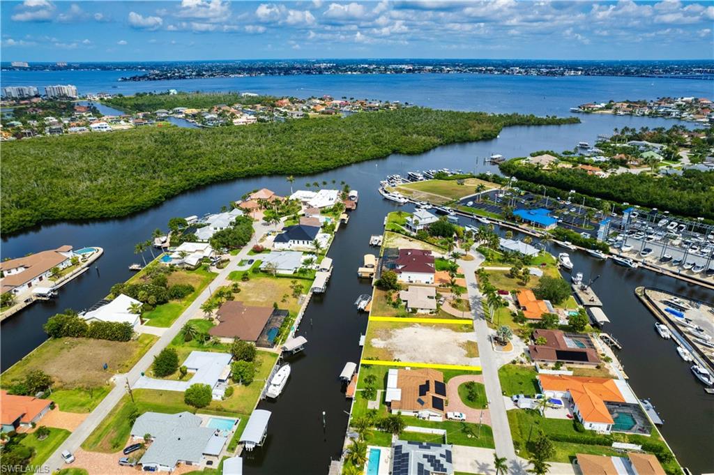 View of property location with a nearby body of water and nearby suburban area