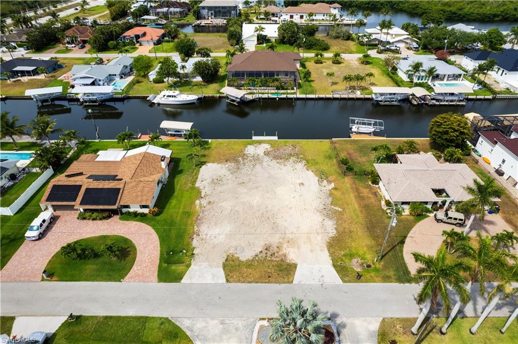 Aerial view of residential area featuring a nearby body of water