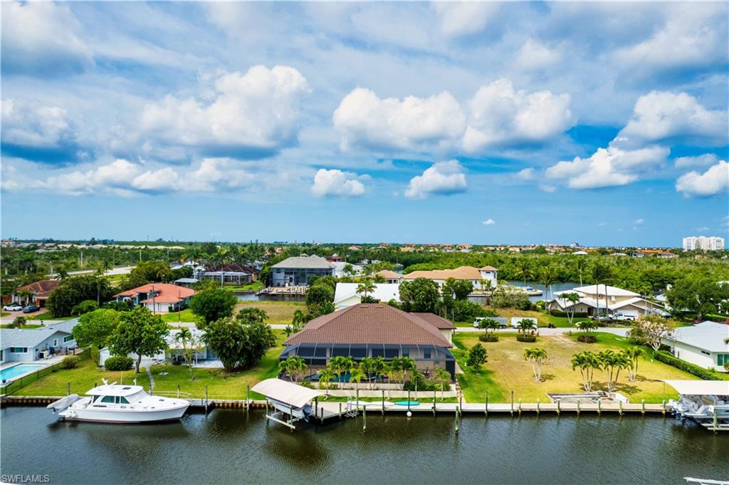 Aerial perspective of suburban area featuring a nearby body of water