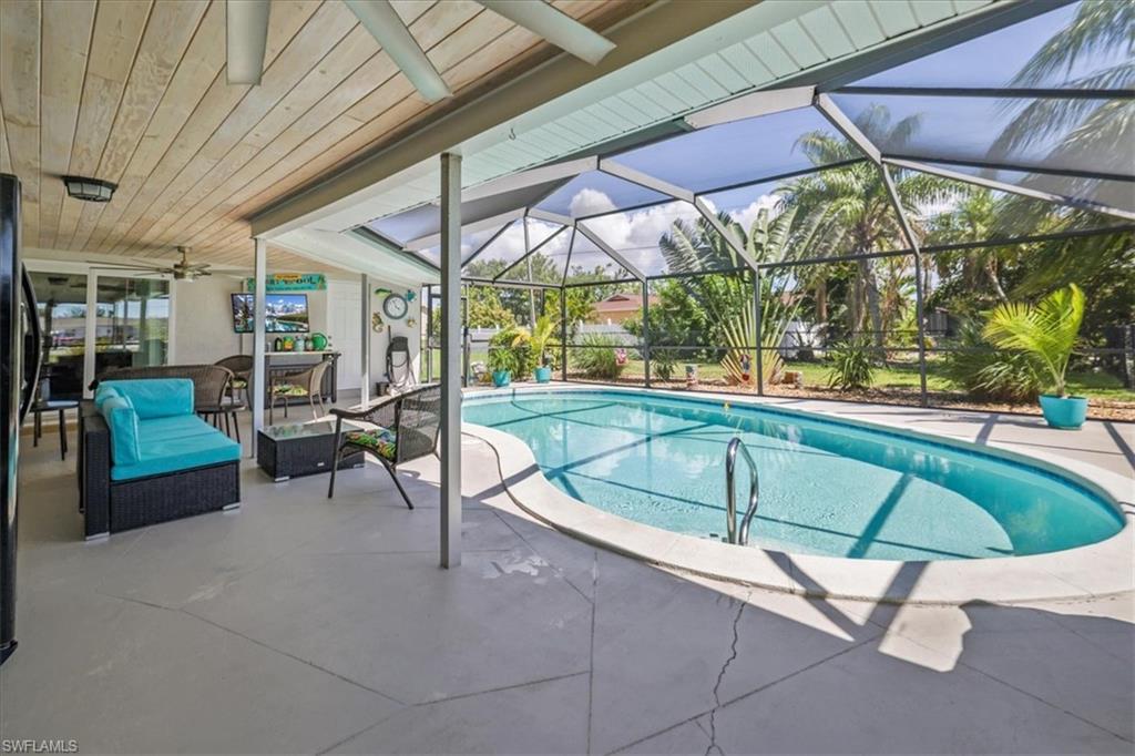 Swimming pool featuring a patio area, ceiling fan, an outdoor hangout area, and a lanai