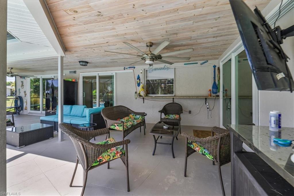View of patio featuring an outdoor hangout area and a ceiling fan