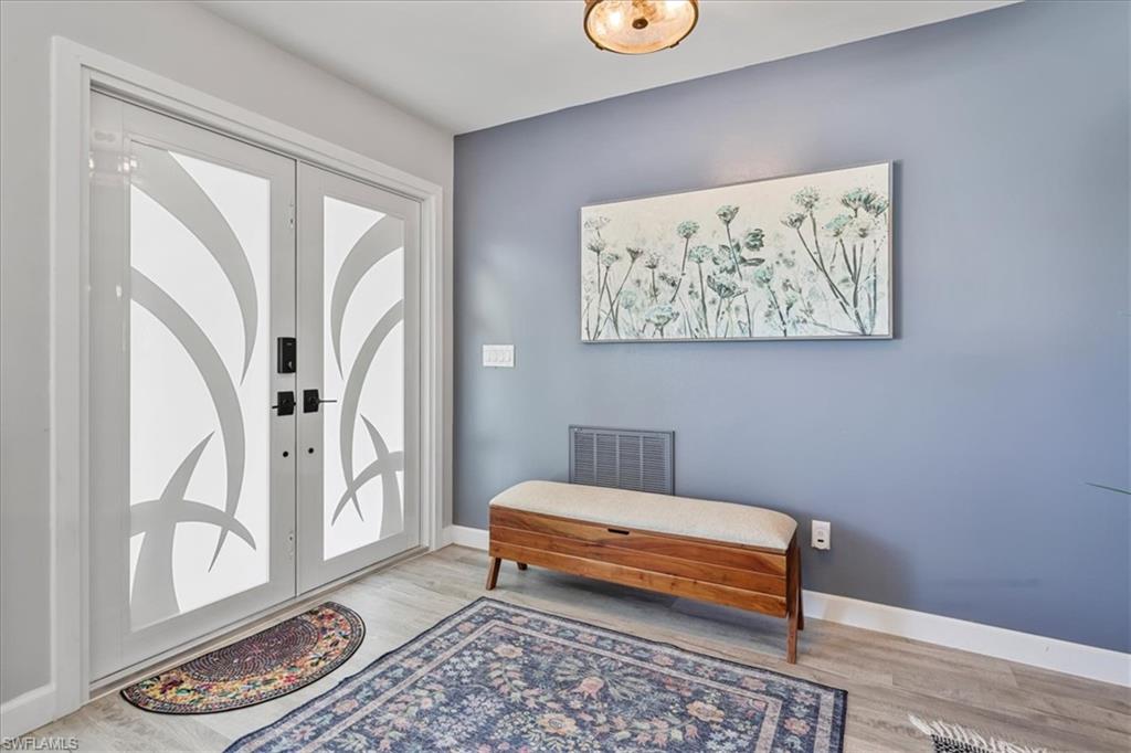 Foyer with wood finished floors and baseboards