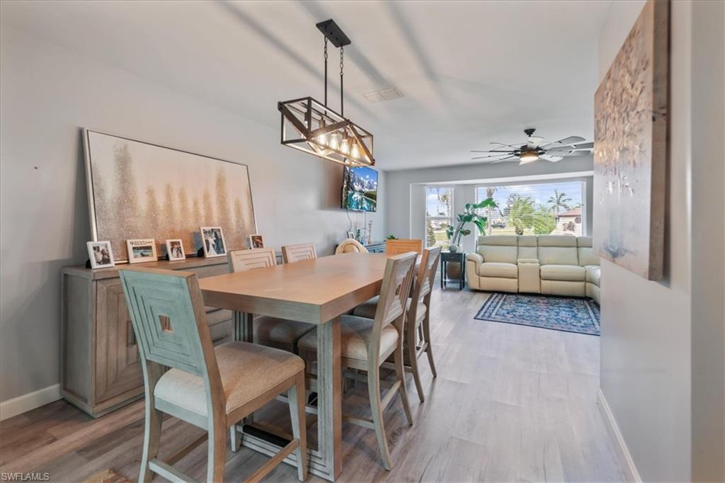 Dining space with light wood-style floors, baseboards, and ceiling fan