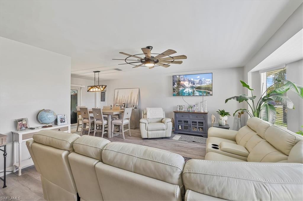 Living room featuring light wood-type flooring and a ceiling fan