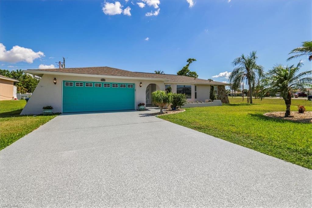 Single story home with a garage, stucco siding, concrete driveway, and a front yard