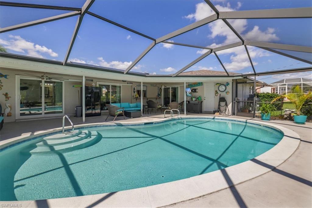 Outdoor pool with ceiling fan, outdoor lounge area, a patio, and a lanai