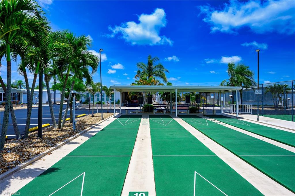 View of property's community featuring shuffleboard