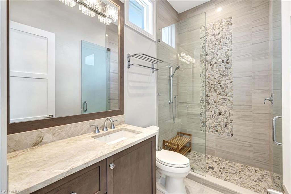 Guest 2 Full bath featuring a shower stall, toilet, and vanity