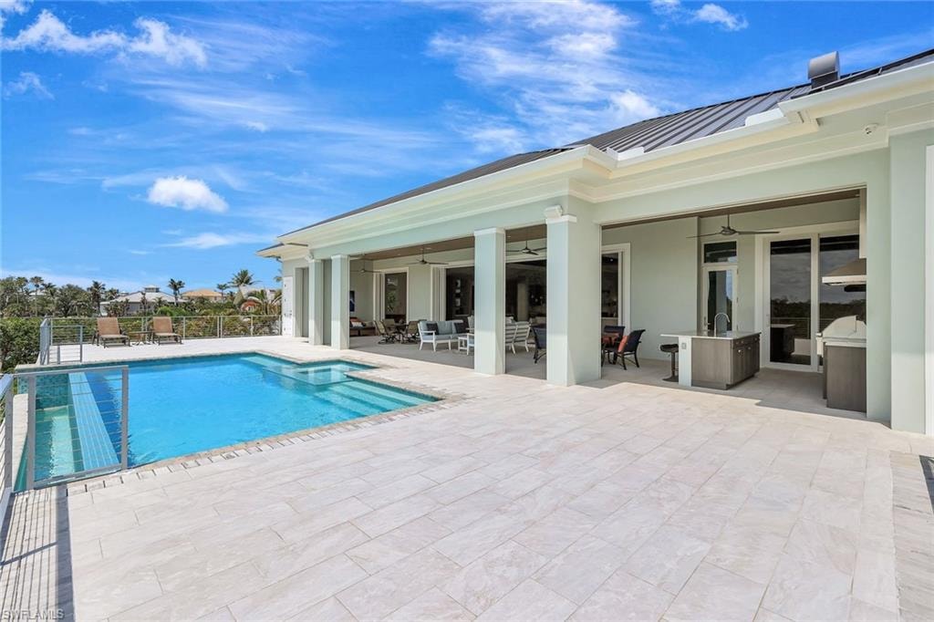 View of pool featuring ceiling fan, a patio area, outdoor dining space, fence, and outdoor lounge area